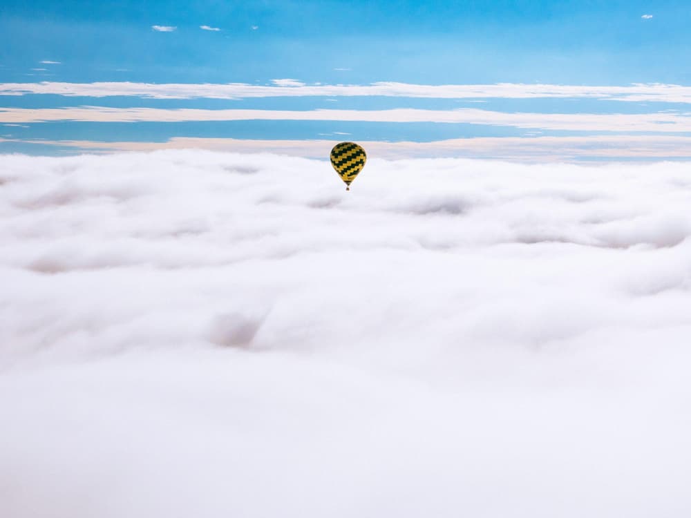 hot air balloon above the clouds